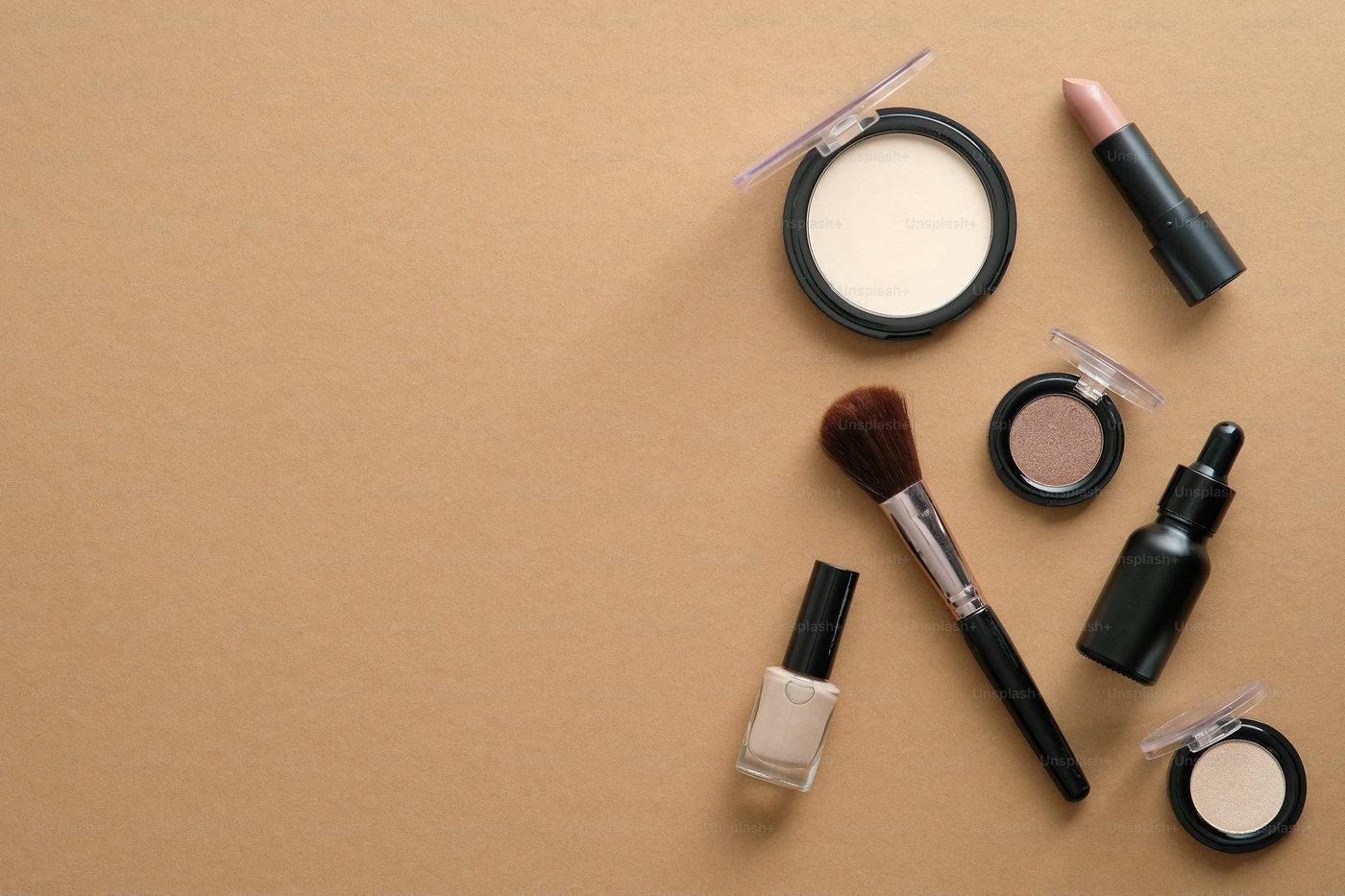 Illustrative flat lay of makeup tools and compacts